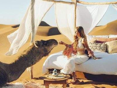 Morocco best sahara tours, camel with woman, 4 Days Desert Trip From Fes to Marrakech via Sahara Desert